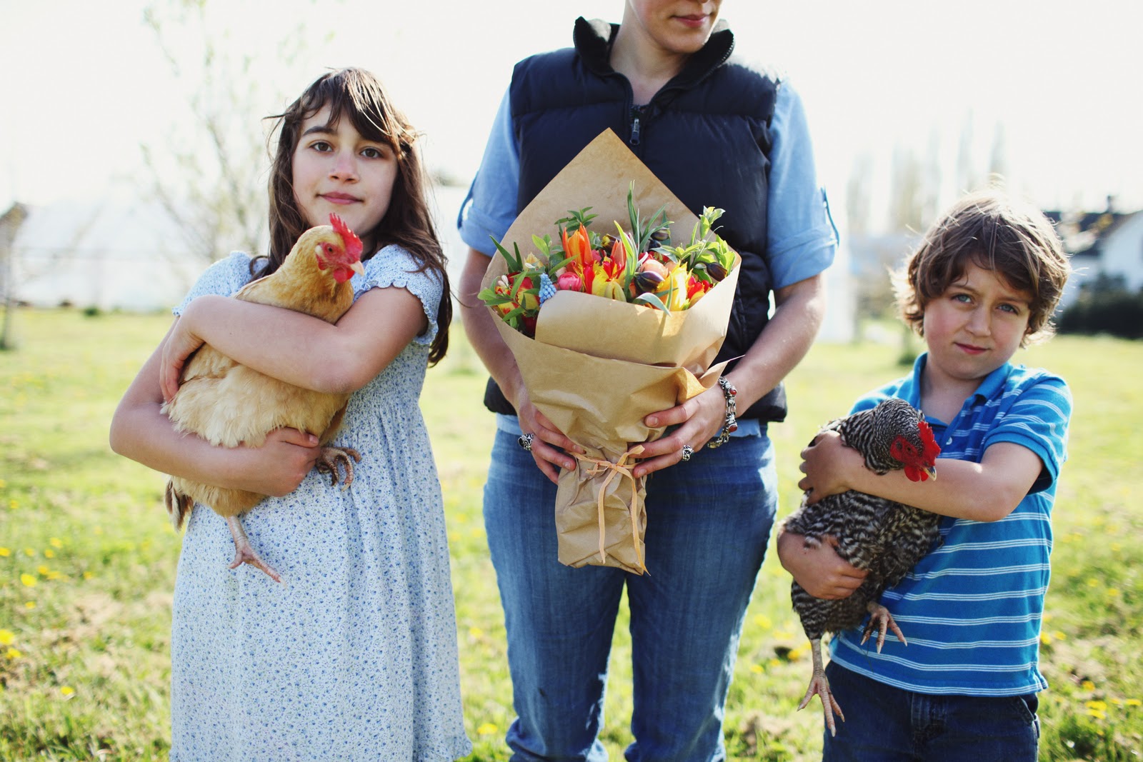Elora, Erin, and Jasper Benzakein with chickens