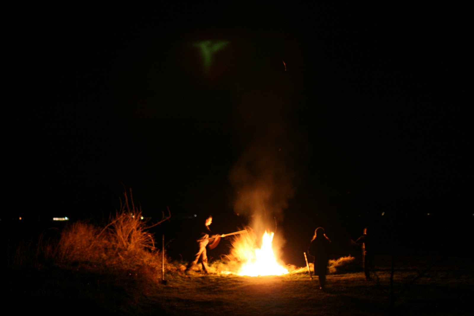 People tending a bonfire