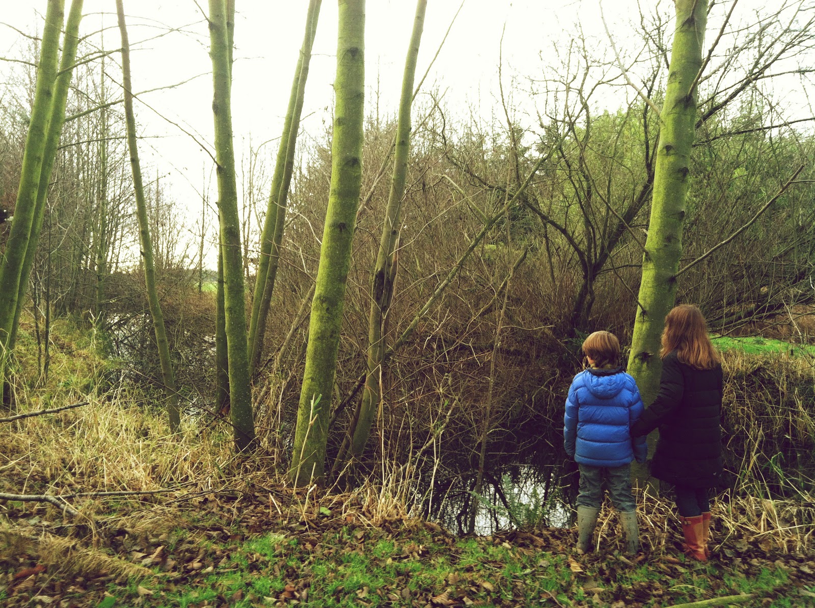 Elora and Jasper Benzakein standing by a pond