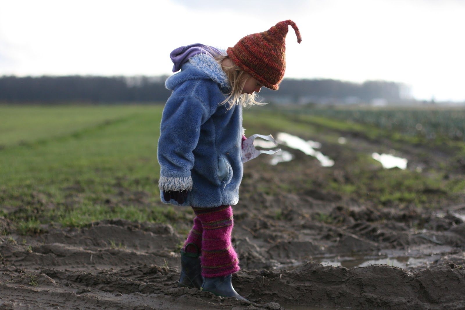 A child in a muddy field