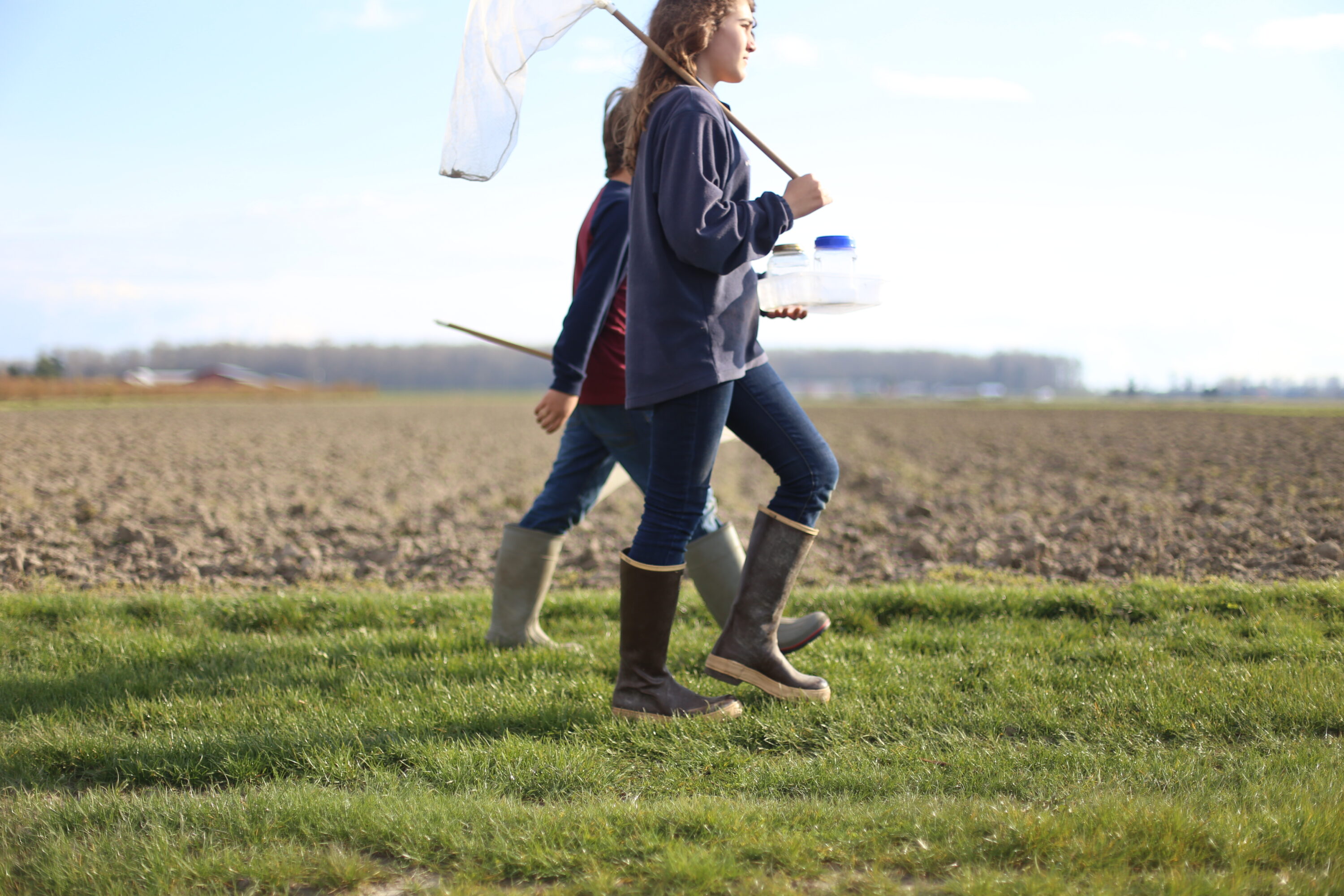 Elora and Jasper Benzakein walking through a field