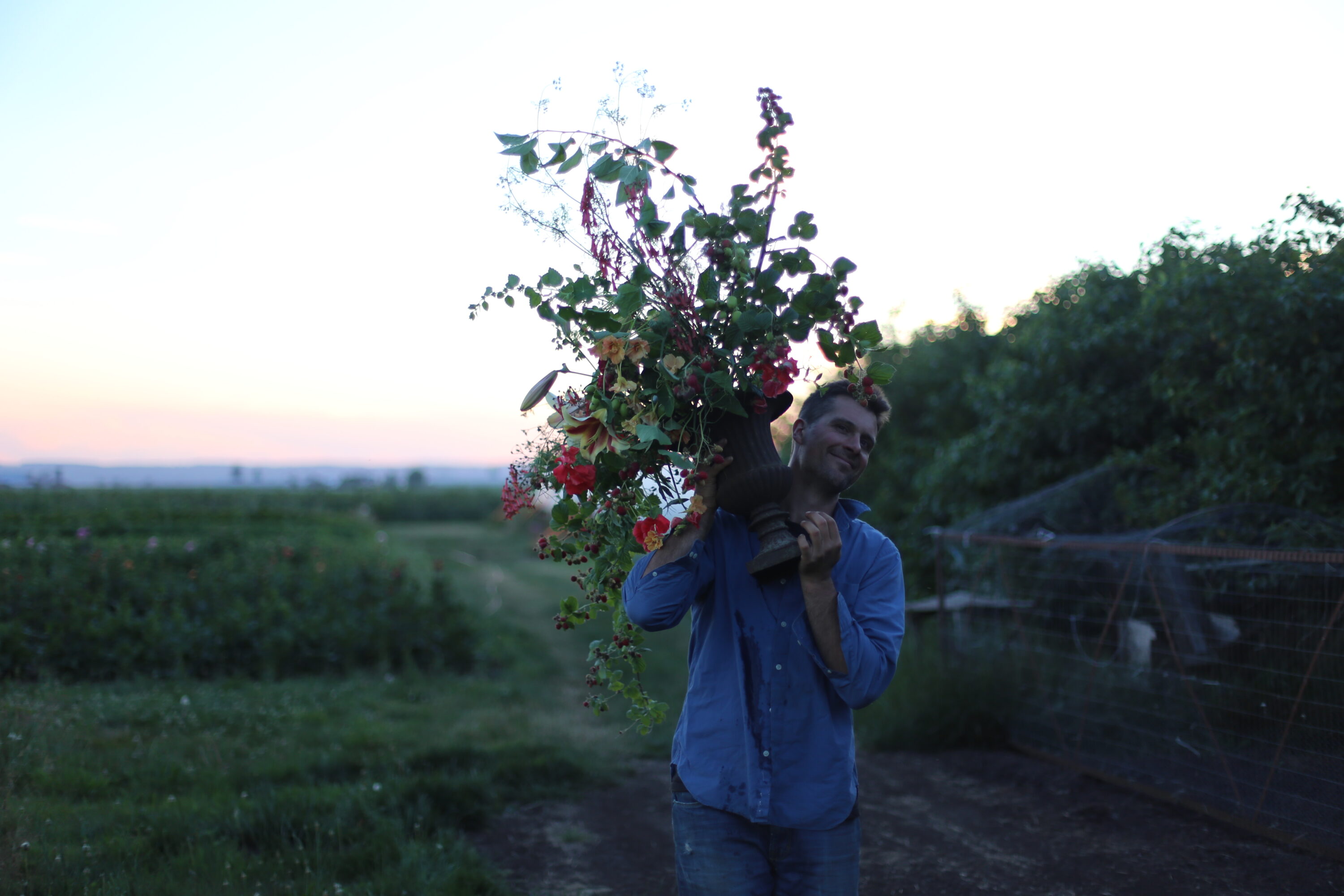 Chris Benzakein carrying a seasonal flower arrangement