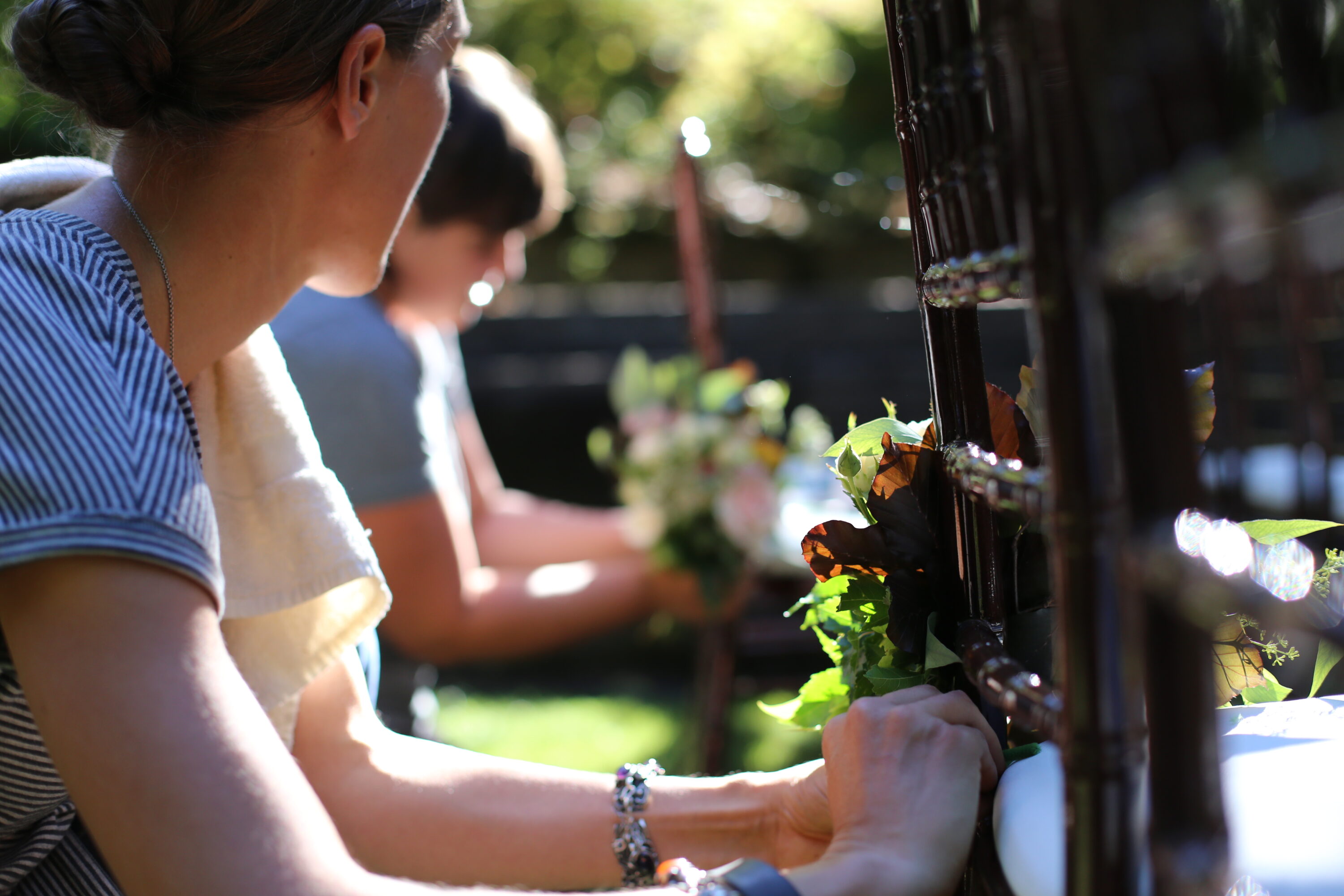 Erin Benzakein and Jill Jorgensen arranging flowers at a wedding