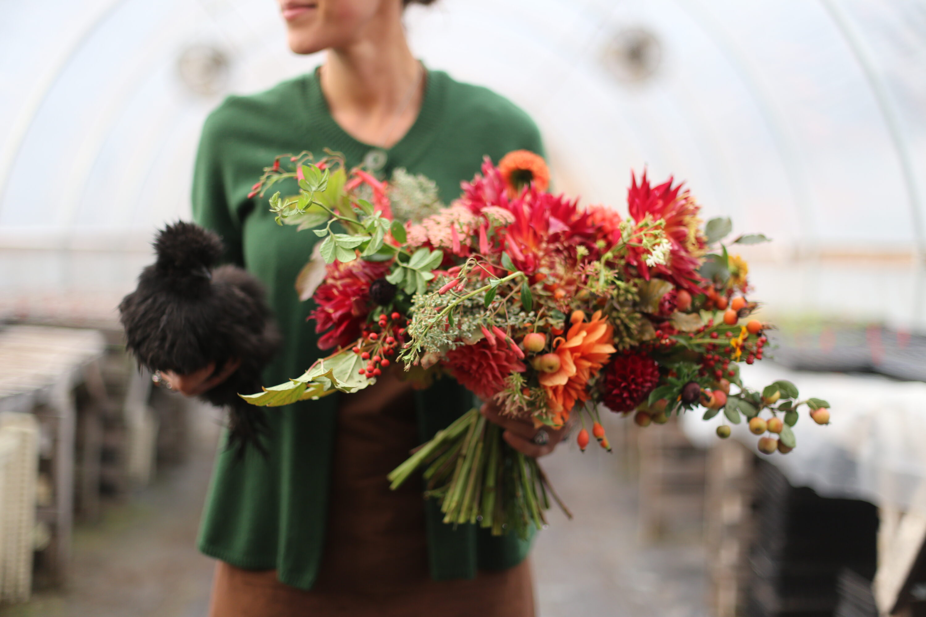 Erin Benzakein holding a bouquet and a chicken
