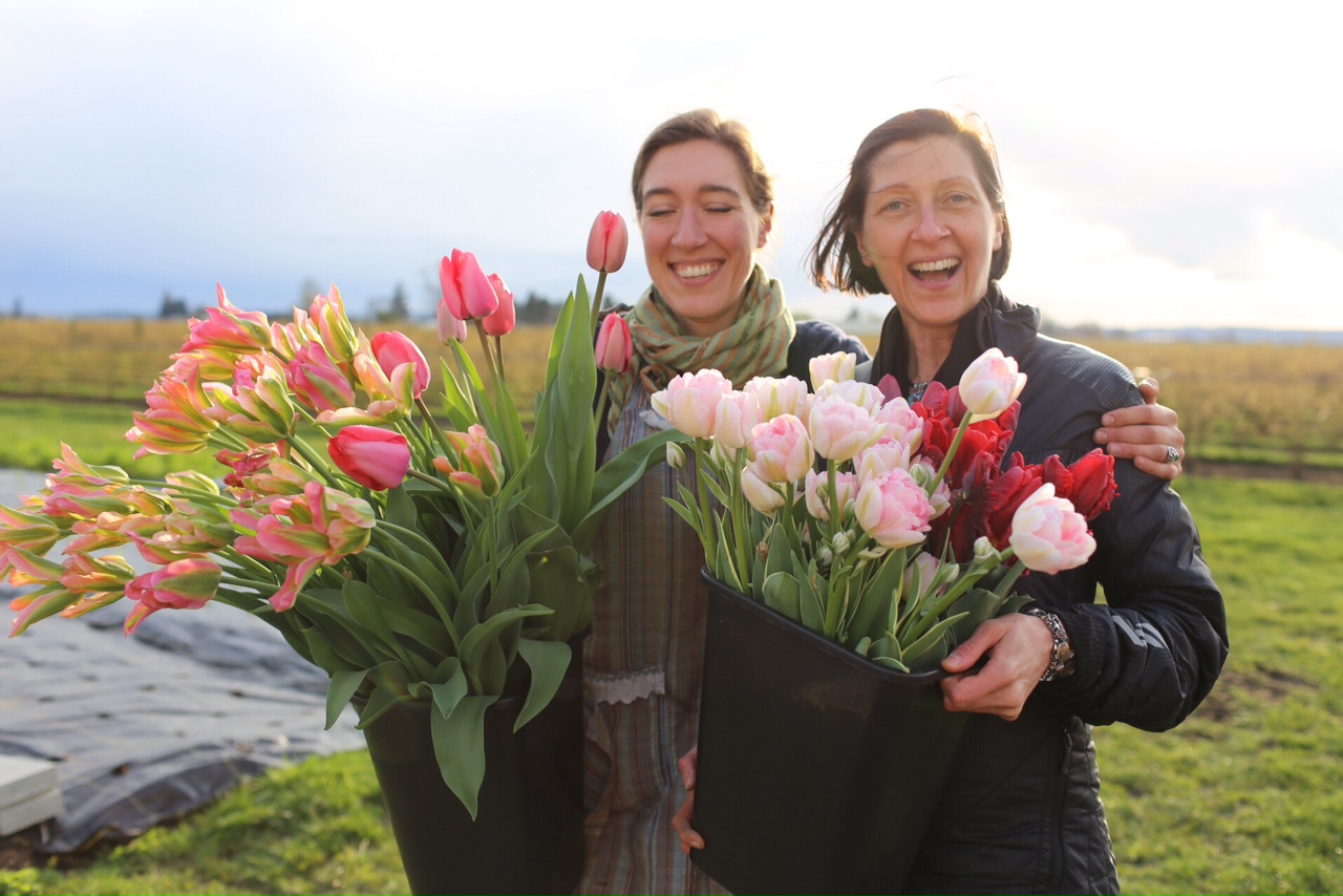 Erin Benzakein and Cherie Claire with buckets of tulips