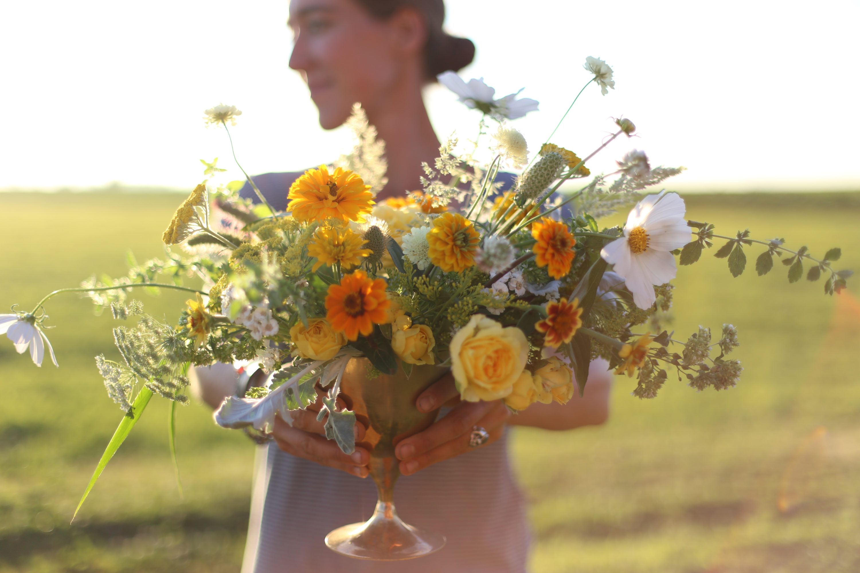erin benzakein holding a wildflower arrangement