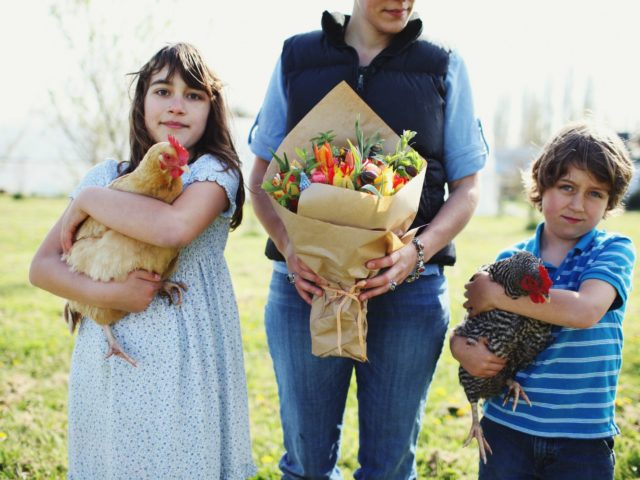 The Benzakein Family with flowers and chickens