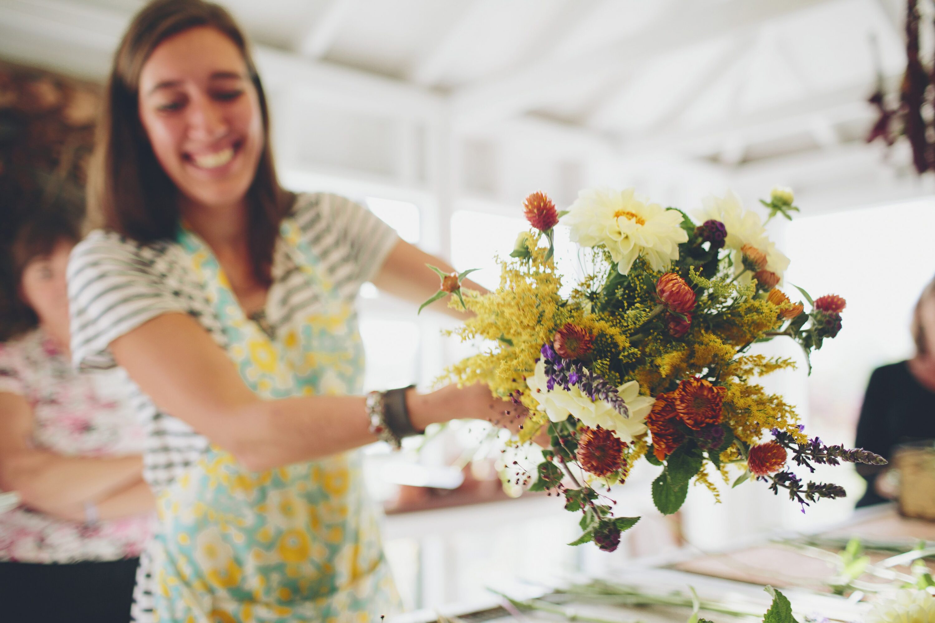 Erin Benzakein smiling and holding a bouquet