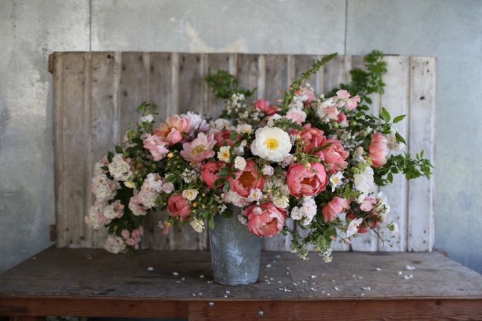 Bouquet includes: 'Coral Charm' peonies, rose 'Ghislaine de Feligonde' and 'Dupontii', apples, sweet peas, foxglove, wild roses, ninebark foliage.