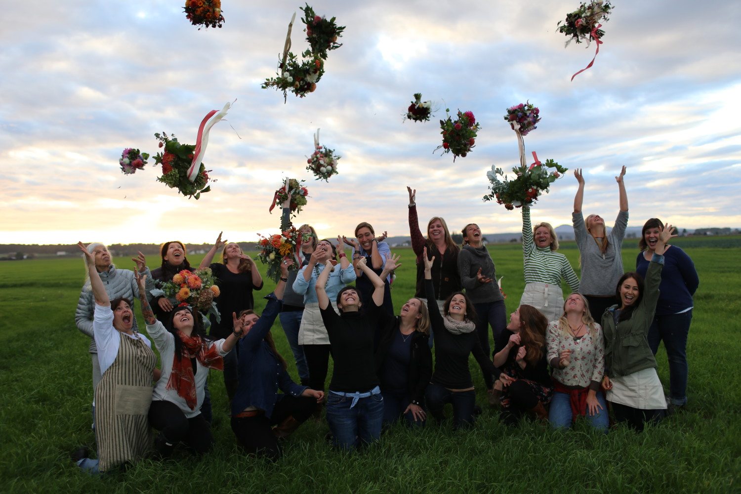 Floret workshop students throwing bouquets in the air