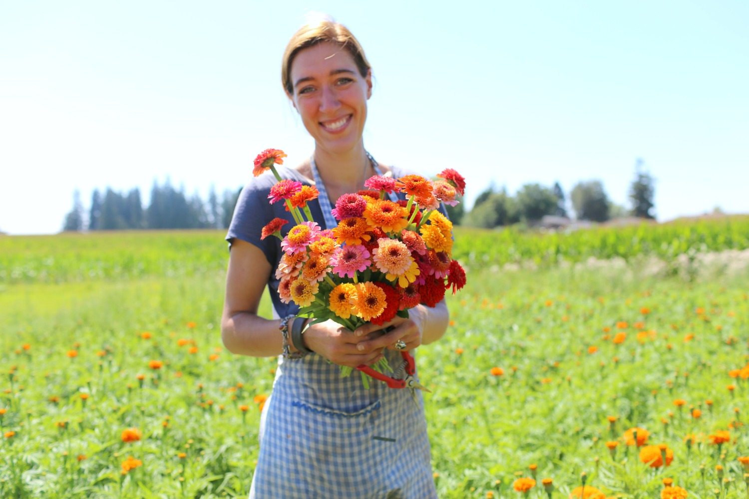 Erin Benzakein holding a bunch of zinnias