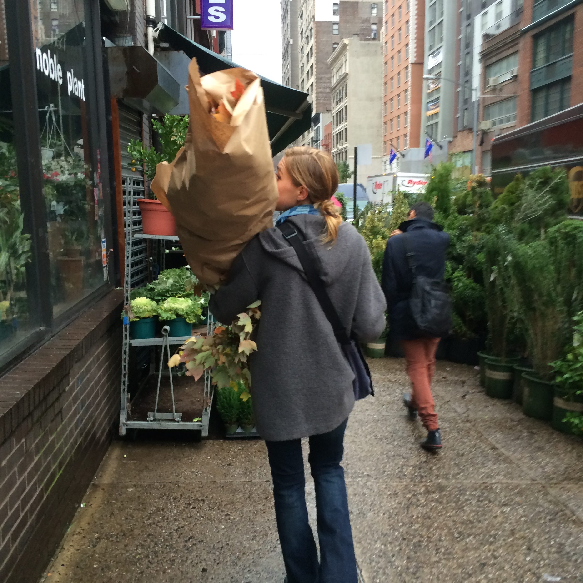 Erin Benakein carrying a large package of flowers