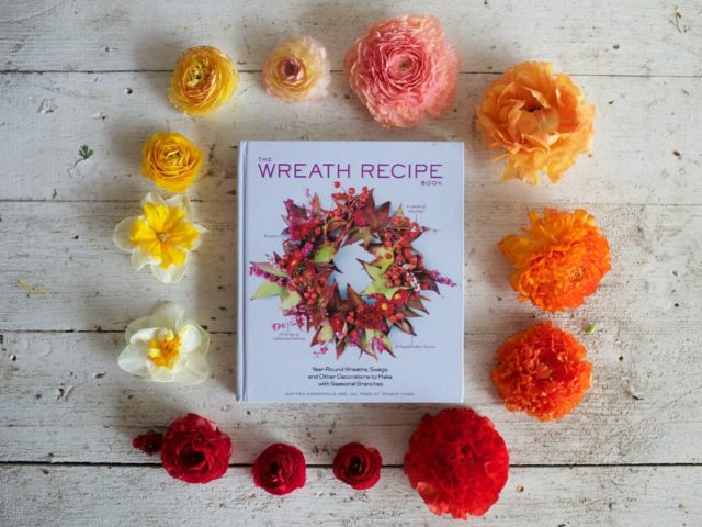 The Wreath Recipe Book surrounded by flowers