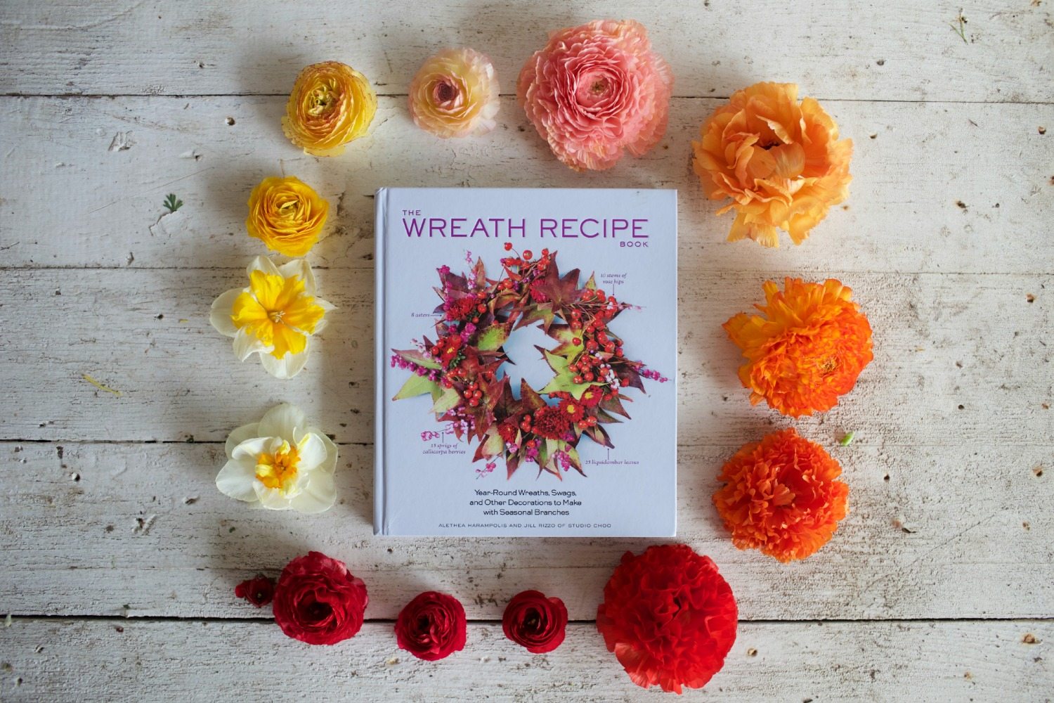 The Wreath Recipe Book surrounded by flowers