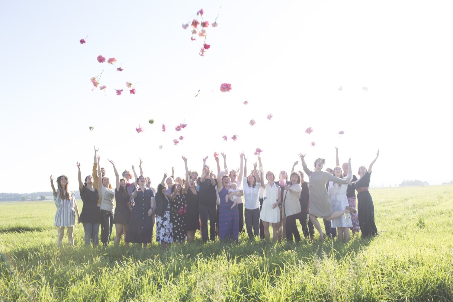 Floret workshop participants throwing flowers in the air