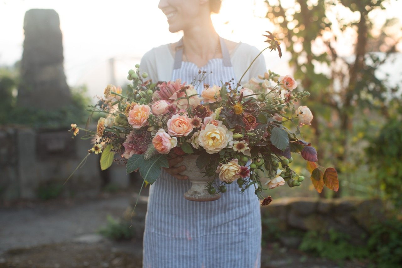 Erin Benzakein holding a flower arrangement