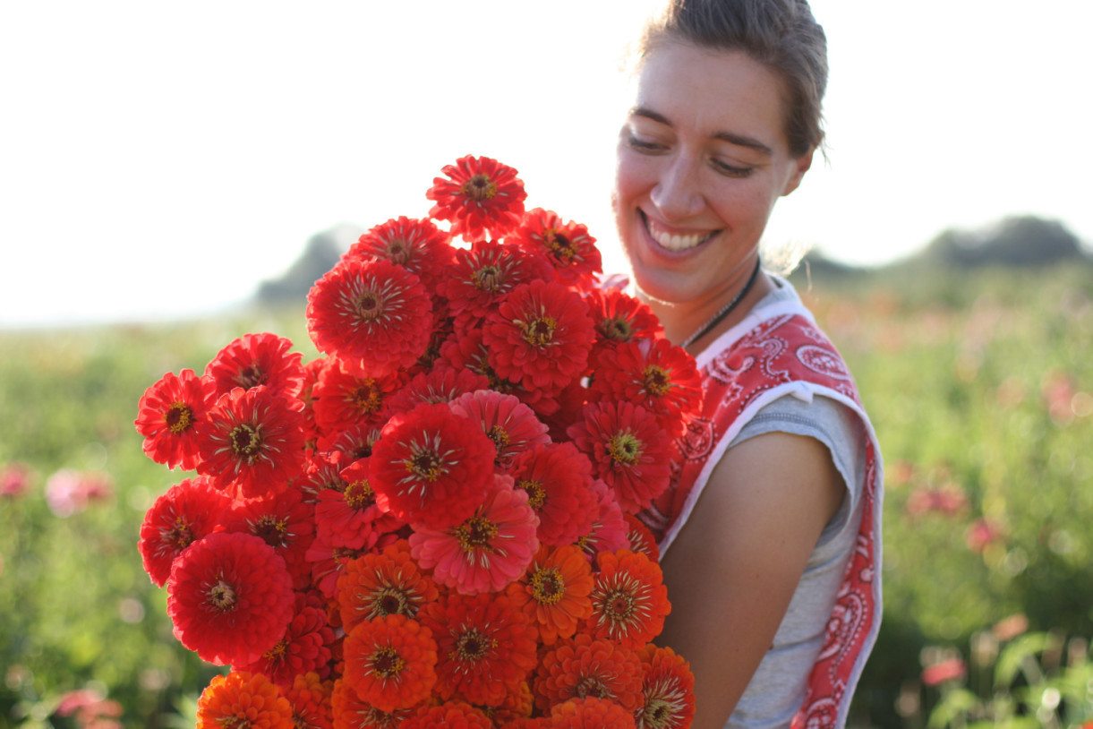 Erin Benzakein holding an armload of zinnias