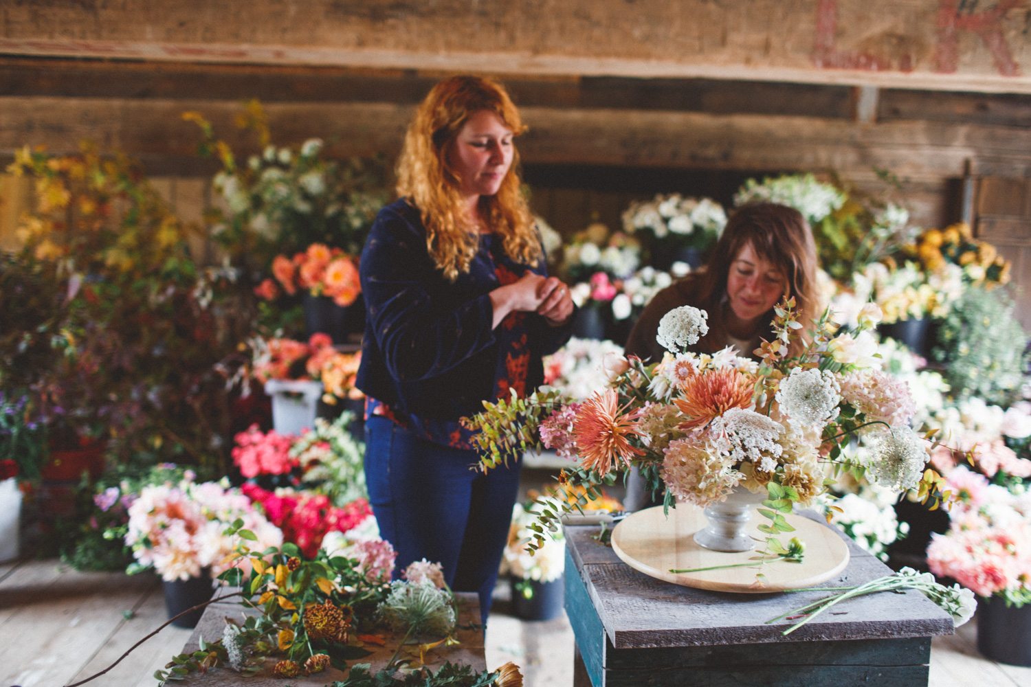 Two women arranging flowers