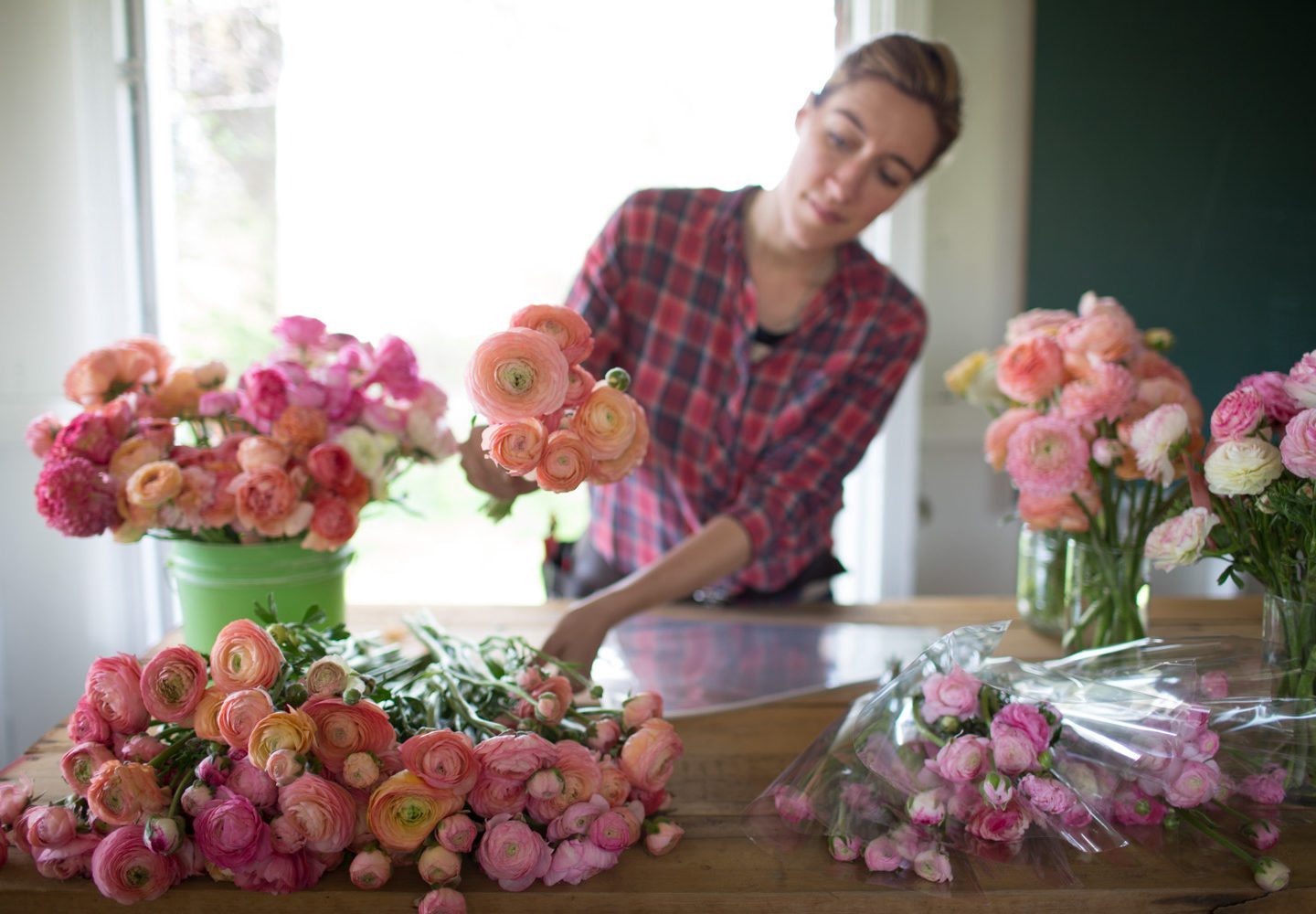 Erin Benzakein arranging flowers in a studio