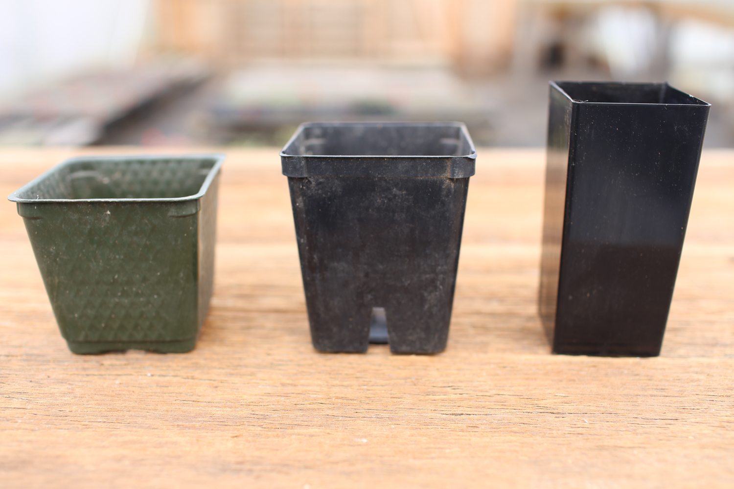 Three differently sized plastic pots
