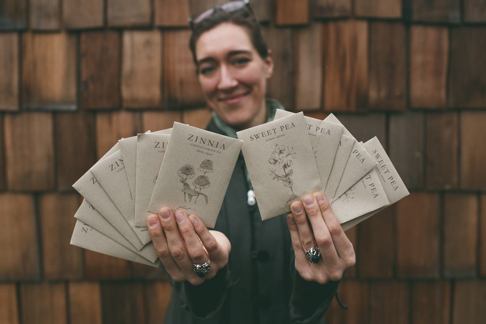 Erin Benzakein holding packets of Floret seeds