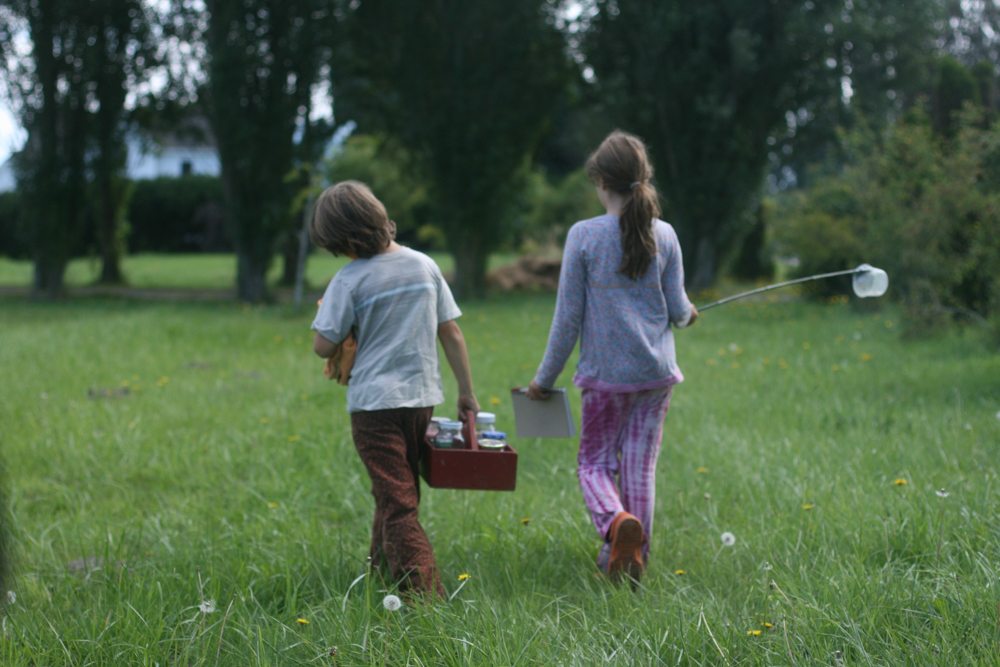 Two children carrying jars of water