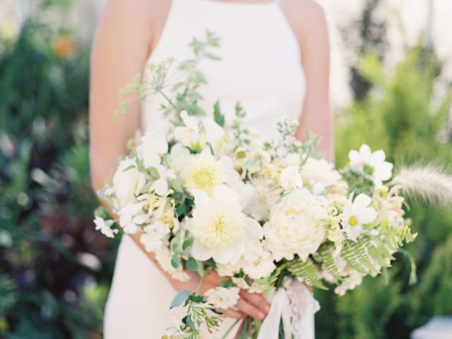 A woman holding a bridal bouquet