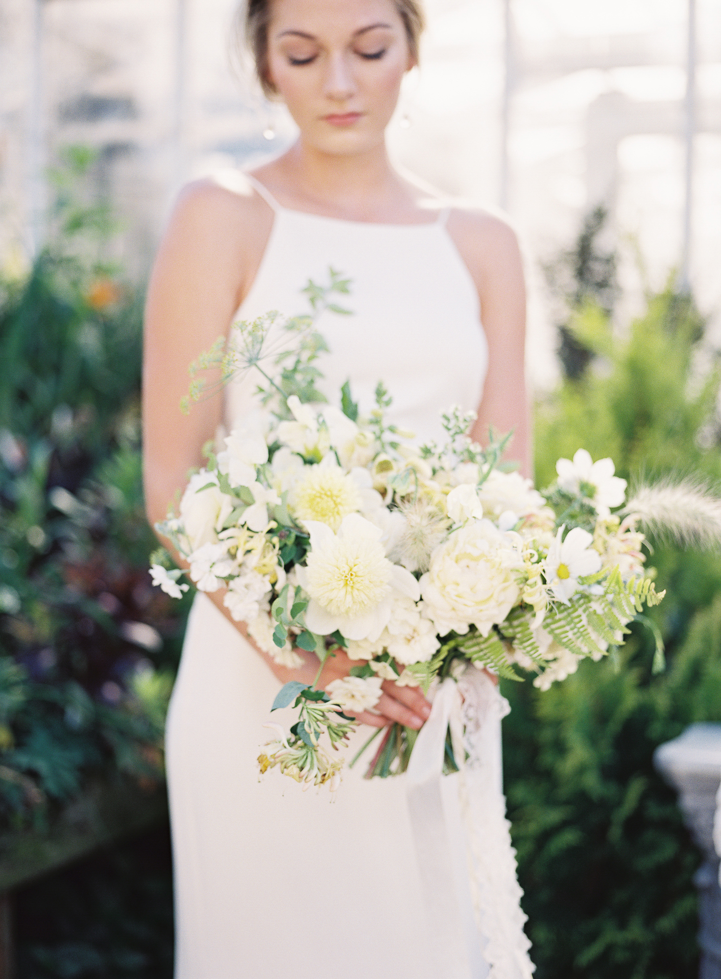 A woman holding a bridal bouquet