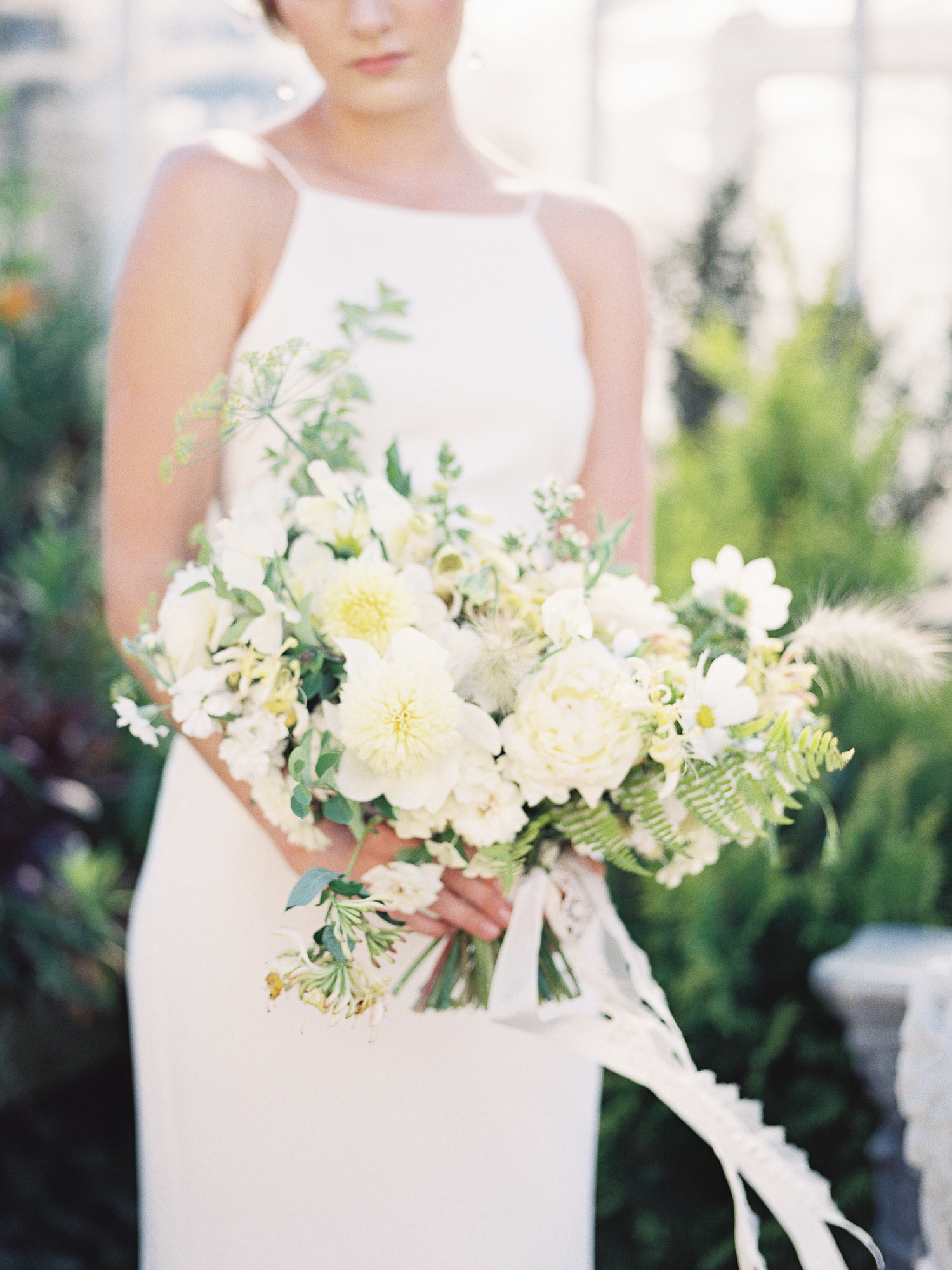A woman holding a bridal bouquet