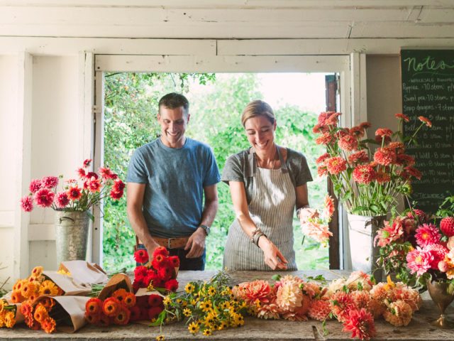 Erin and Chris Benzakein arranging flowers in the studio