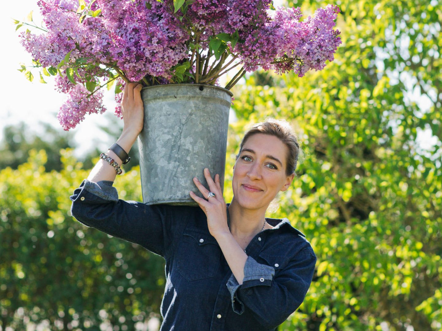 Erin Benzakein with a bucket of lilacs