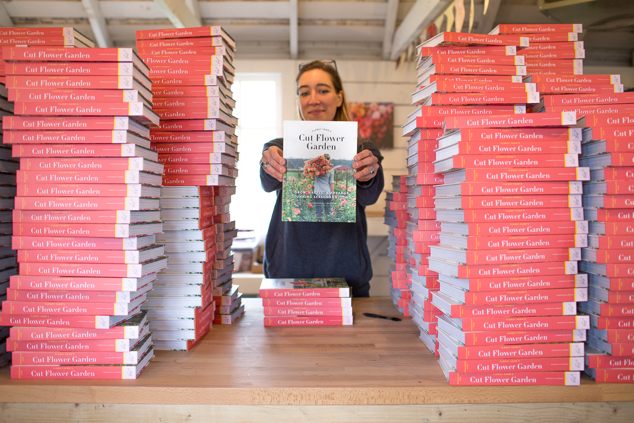 Erin Benzakein surrounded by stacks of the Floret book