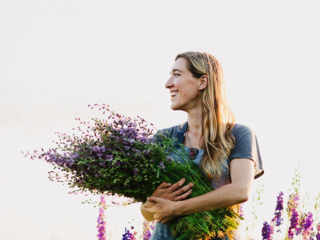 Erin Benzakein in the field with an armload of flowers