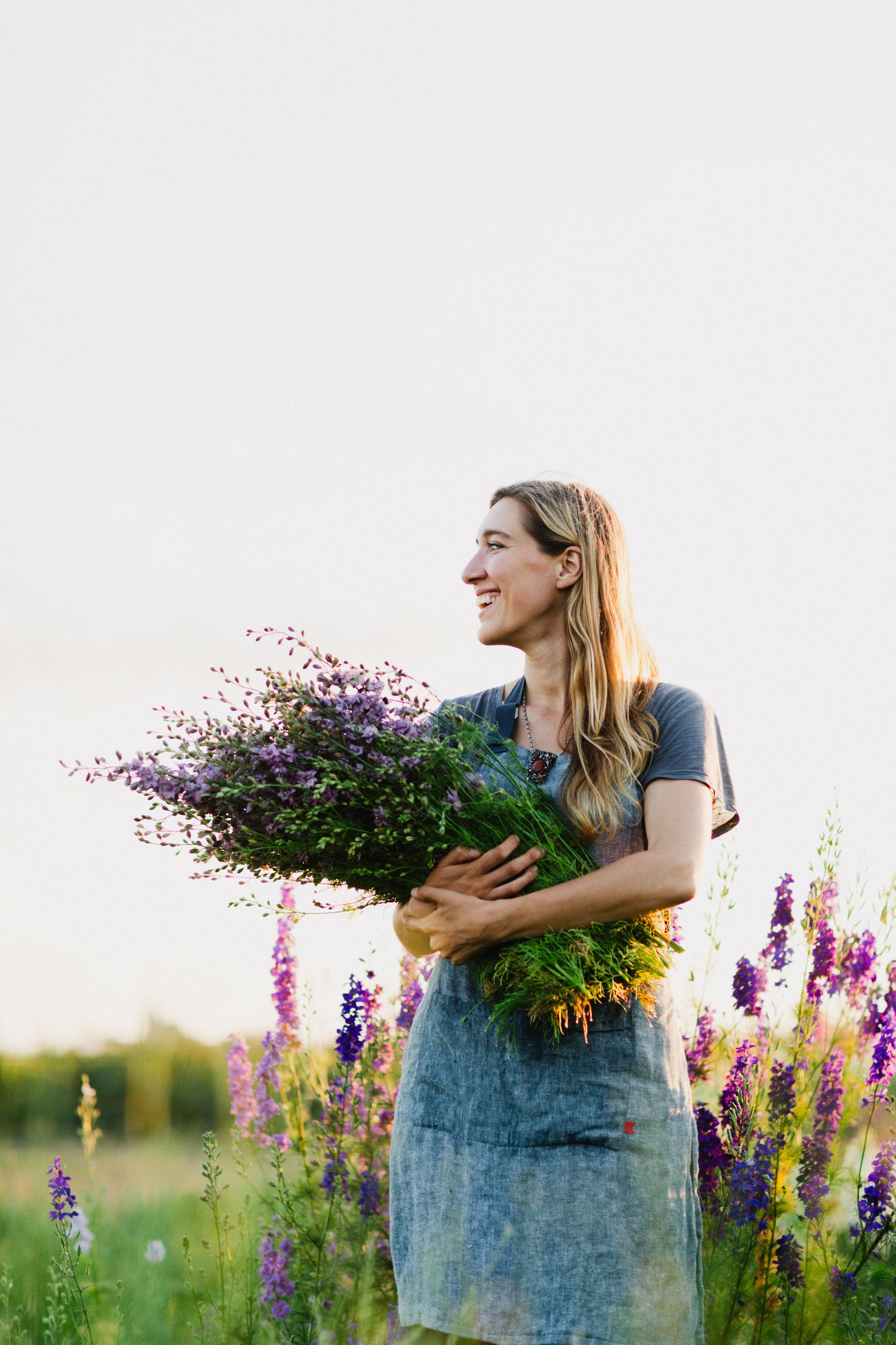 Erin Benzakein in the field with an armload of flowers