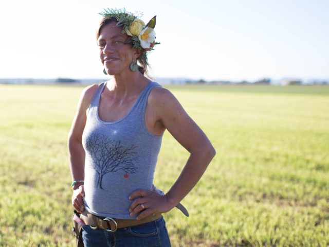 A woman wearing a floral headpiece