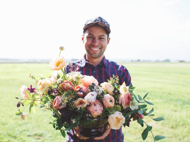 A man holding a flower arrangement