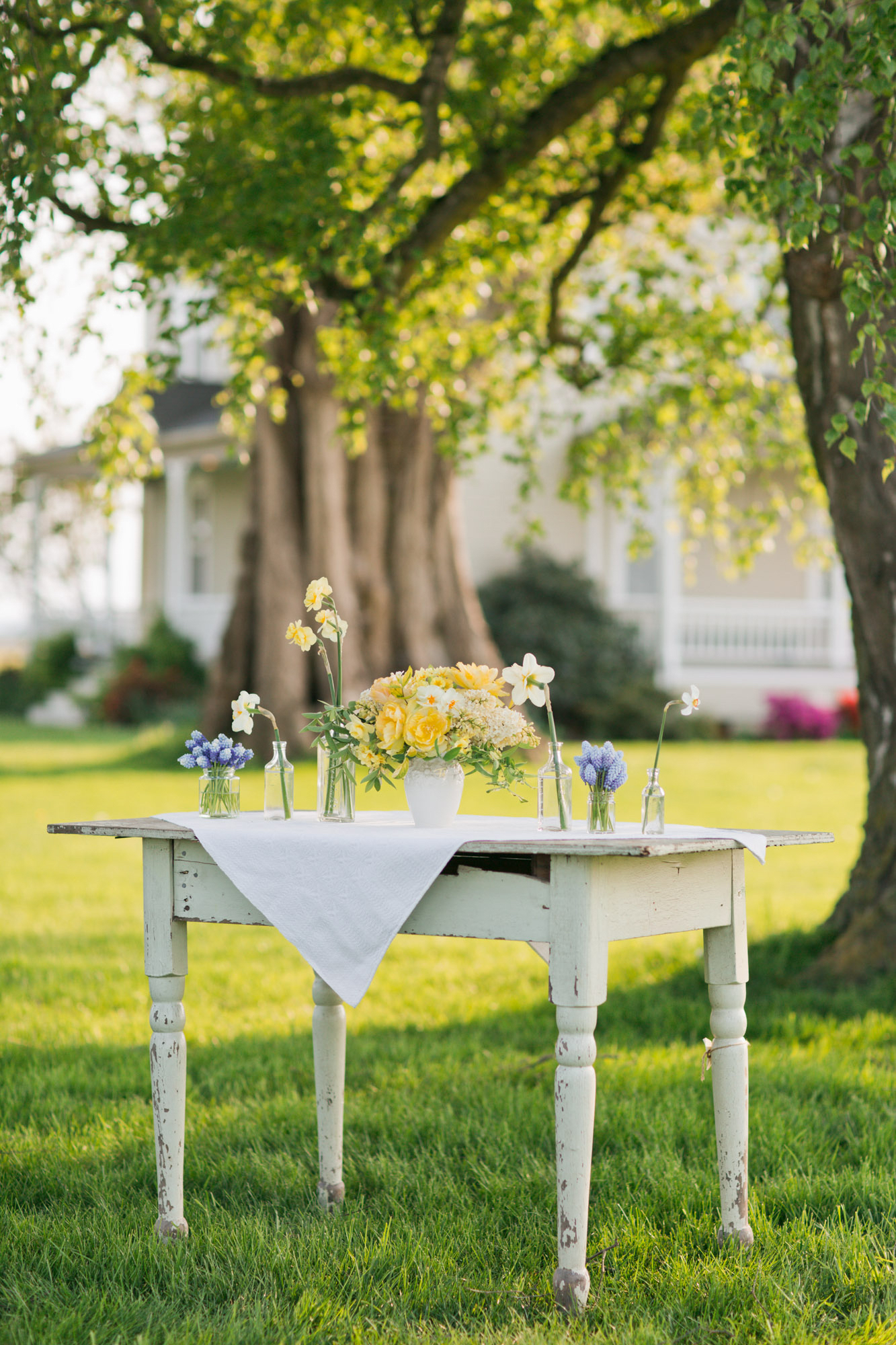 Vases of flowers on a table outdoors