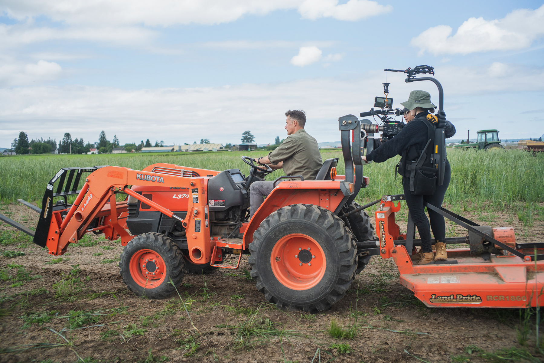 Chris Benzakein driving a tractor while being filmed