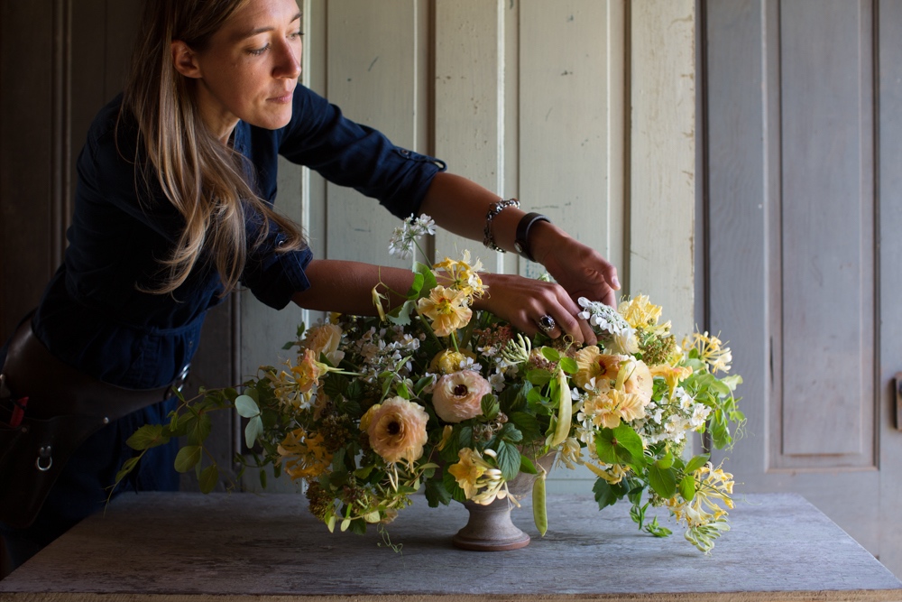 Erin at Floret designing a floral centerpiece using edibles