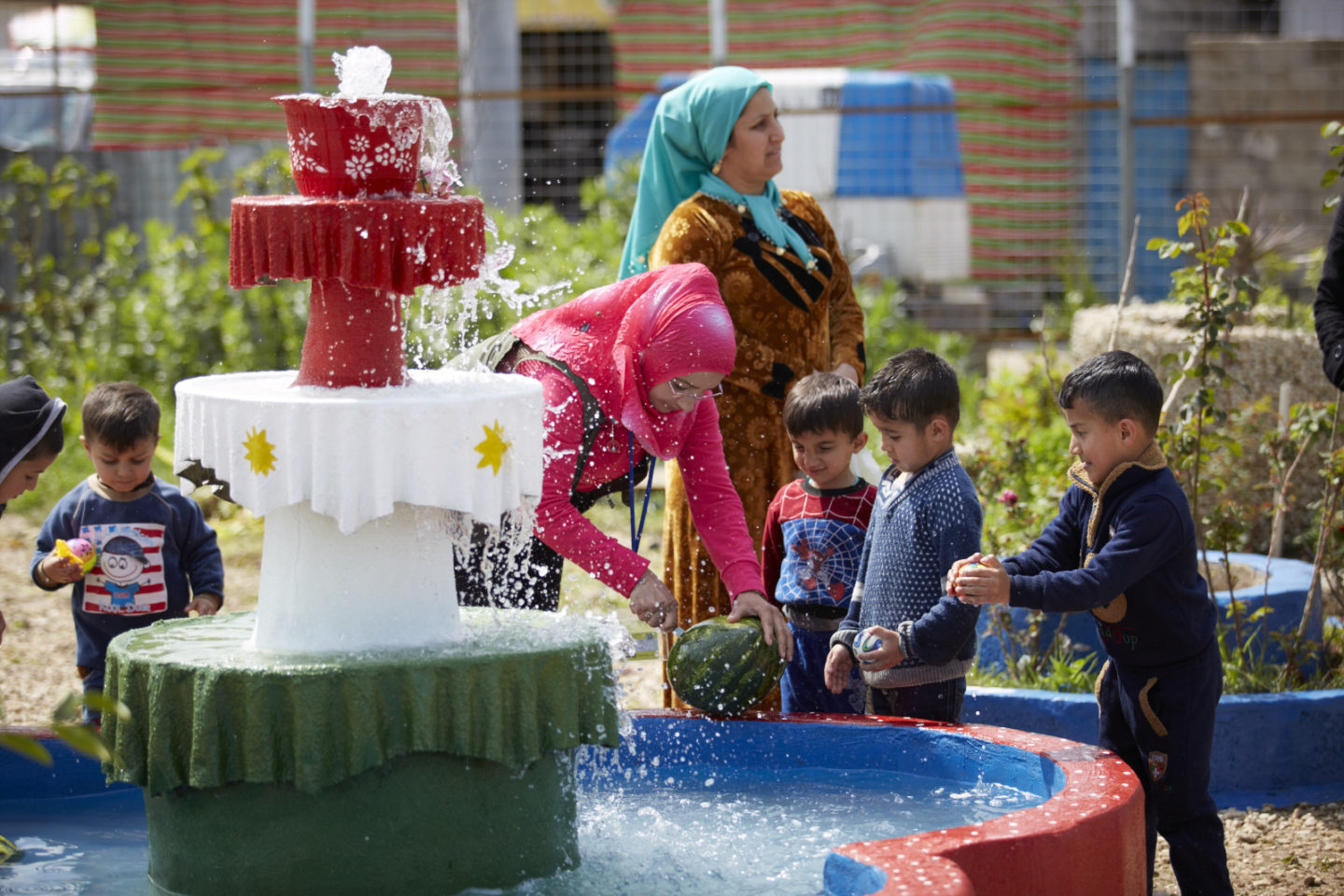 Woman with small boys at fountain