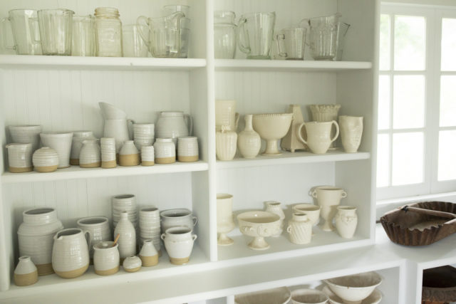 Shelves of flower vessels in the Floret studio