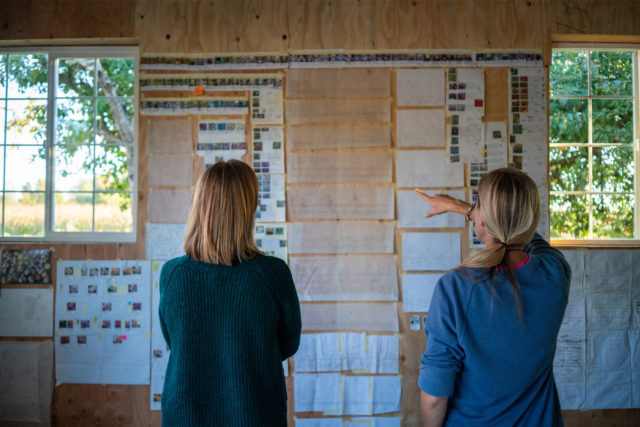 Erin Benzakein and Becky Crowley hang up planning material for the new farm design.
