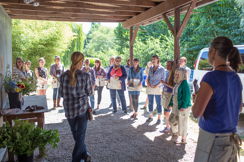 Group of students gathered around Erin Benzakein at one of the first on-farm Floret workshops