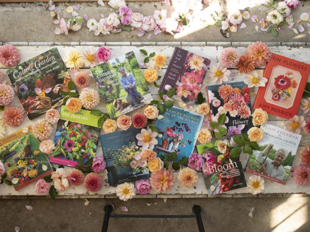 Overhead of Floret's favorite books surrounded by dahlias and roses