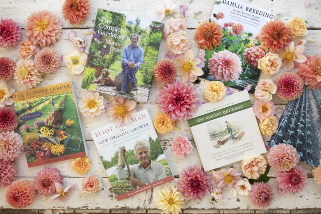 Overhead of Floret's favorite gardening books surrounded by dahlias