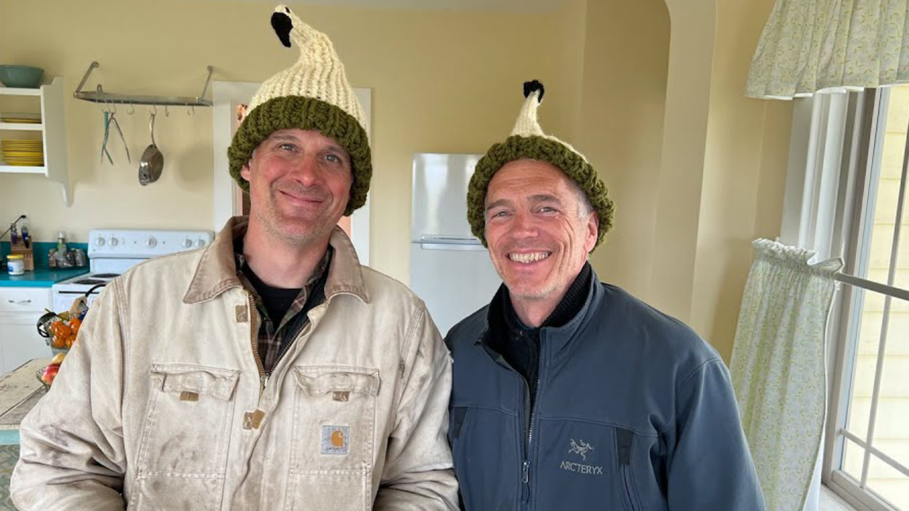 Chris Benzakein and Jamie Francis wearing snit swan hats