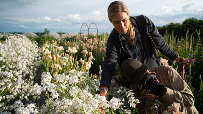 Erin and Chris Benzakein photographing flowers in the Floret cutting garden