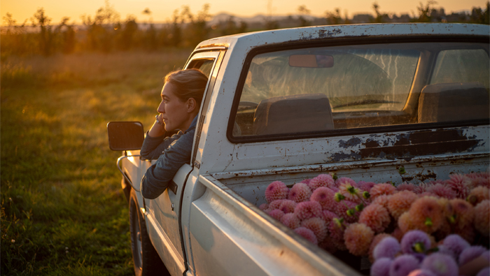 Erin Benzakein looking at the sunset while sitting in the Floret truck