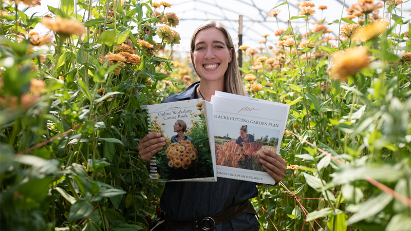 Erin Benzakein holding the Floret Online Workshop Course Book and 1/4 Acre Cutting Garden Plan