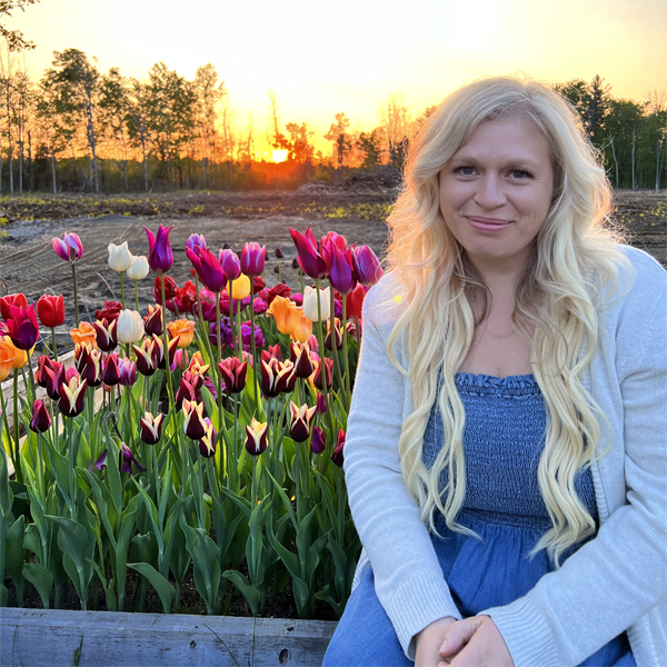 Heather Conn in front of a bed of tulips